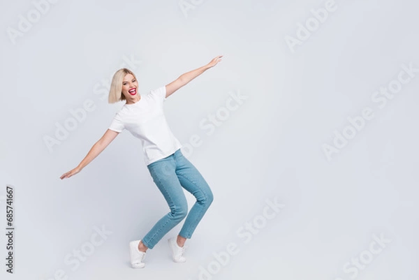 Fototapeta Full length photo of good mood nice girl with bob hair dressed white t-shirt hold arms like wings isolated on gray color background