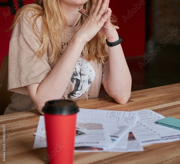 Obraz A young girl thinking about learning materials
