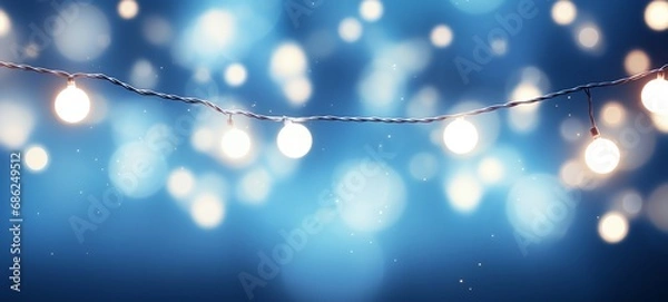 Obraz Christmas holiday and Happy New Year decoration and illumination concept. Garland bokeh lights over blue background.