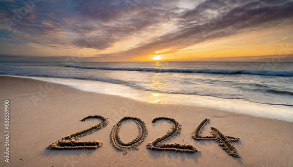 Fototapeta New year, 2024 written in sand on a beach during soft sunset.