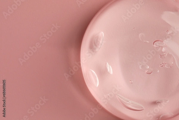 Fototapeta Sample of clear cosmetic gel on pink background, top view. Space for text