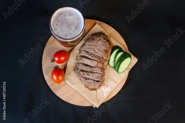Obraz Fried meat with green vegetables with a glass of beer