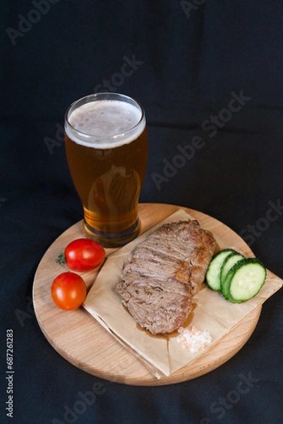 Obraz Fried meat with green vegetables with a glass of beer