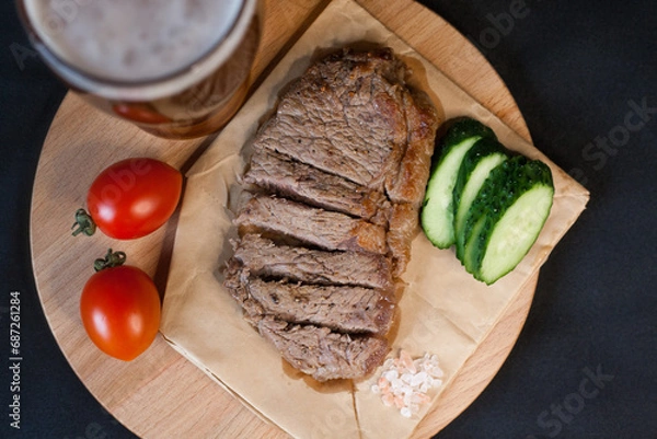 Obraz Fried meat with green vegetables with a glass of beer