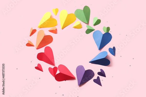 Fototapeta Frame made of colorful paper hearts on pink background. LGBT concept