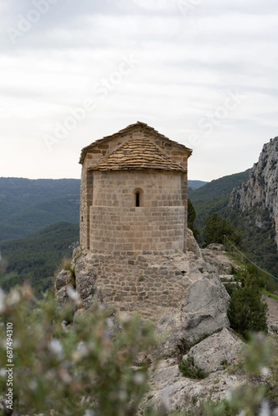 Fototapeta Amazing view of Ermita de La Pertusa above the lake in Congost de Mont Rebei.