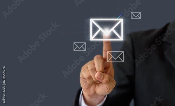 Obraz Communication concept: Businessman hand pressing a letter or email icon , world wide technology.