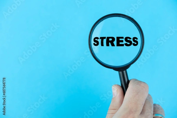 Fototapeta Stress, under magnifying glass focused on the term. A visual representation of the impact, management, and awareness surrounding stress, emphasizing mental health well-being strategies.
