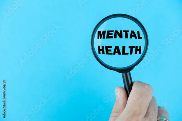 Fototapeta Mental Health, with a magnifying glass focused on the term. A visual representation of the significance of mental well-being, highlighting awareness, support, and breaking stigma.