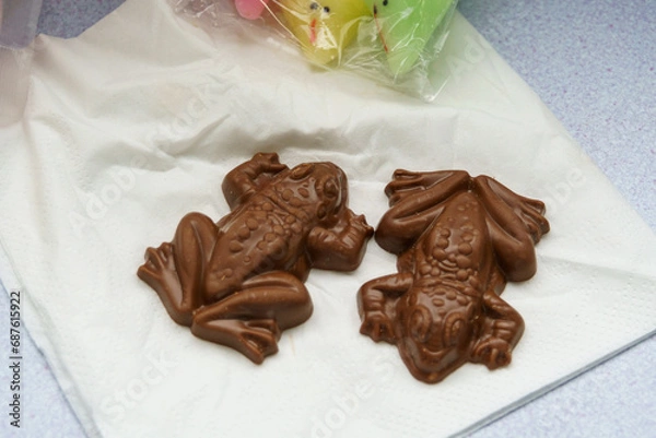 Fototapeta Two chocolate frogs on a napkin