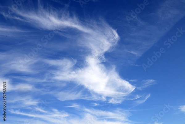 Obraz Beautiful blue sky with white wispy clouds, a perfect replacement background for photos.