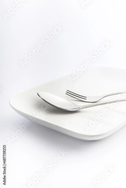 Fototapeta Spoon and fork on white plate on white background, High Key Photography