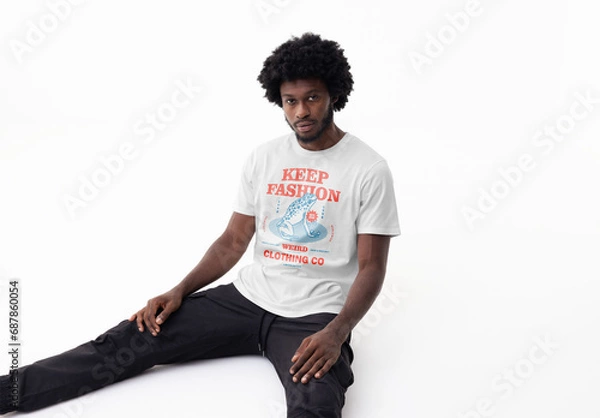 Fototapeta Mockup of man wearing customizable t-shirt sitting on studio floor