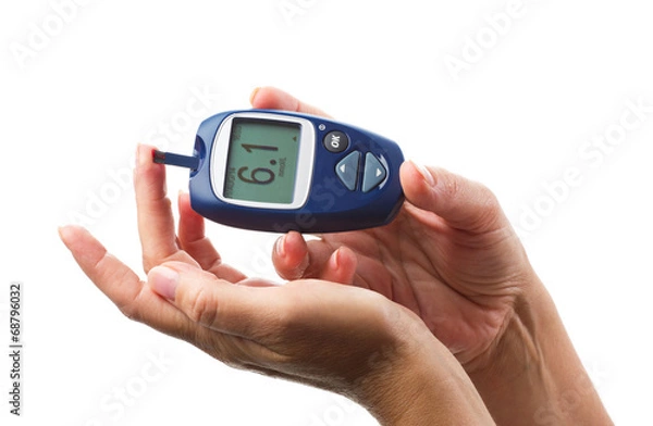 Fototapeta womans hand and glucometer