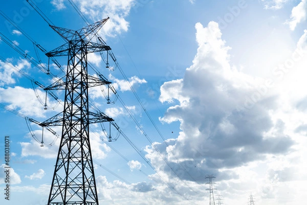 Fototapeta Power pylons and high-voltage lines against the background of the cloudy sky, power lines.