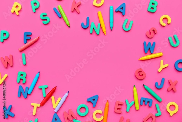 Fototapeta Frame made of colorful letters and markers on pink background