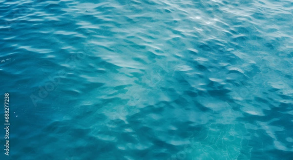 Fototapeta Overhead view of some ripples in a body of rather blue, seemingly deep water.