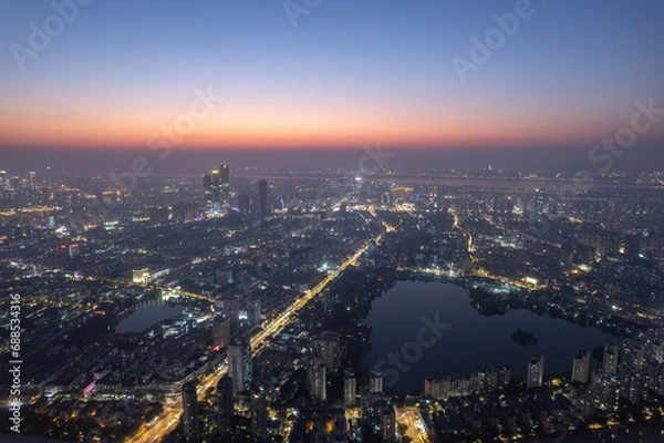 Fototapeta Aerial photography of the night view of Nanjing's Mochou Lake and the bustling city