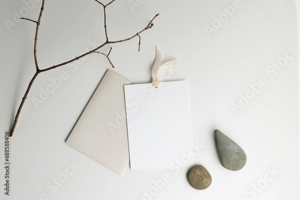 Obraz Flatlay gift certificate envelope with branches and stones with soft lighting