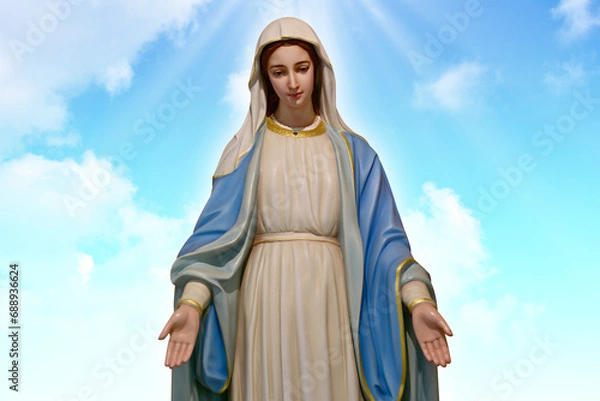 Fototapeta Our lady of grace virgin Mary with Bright Blue Sky and beautiful clouds with abstract colored background and wallpaper.
