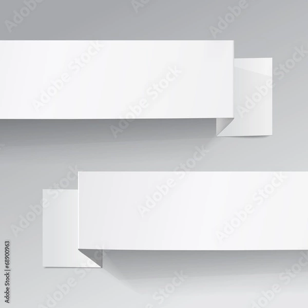 Fototapeta Two white sheets of paper on a grey background. Origami