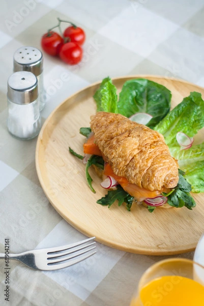 Fototapeta Croissant with smoke salmon and caesa salad.