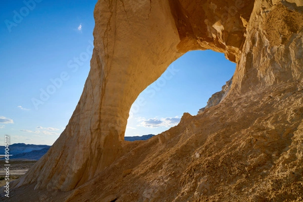 Fototapeta  Natural arch on the Tuzbair salt marsh. Natural arch at Tuzbair is a natural formation carved by erosion.Salt marsh Tuzbair is one of the most famous attractions of the Mangystau region of Kazakhstan