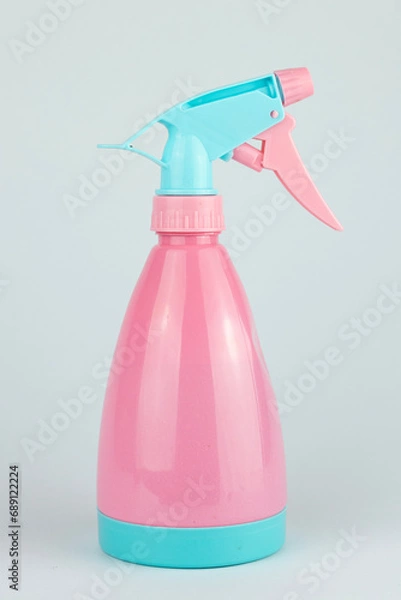 Fototapeta Mist sprayer for watering plants or spraying clothes. The pink bottle is made of plastic.