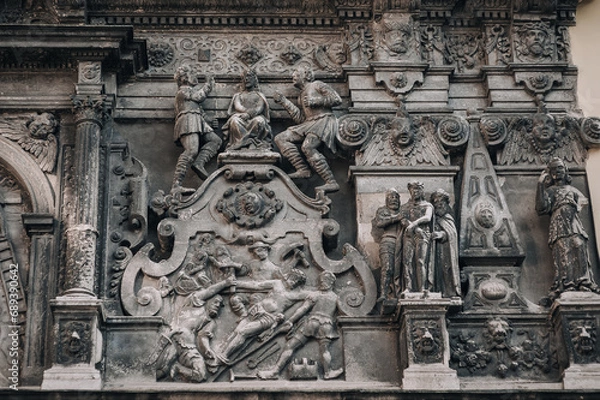Fototapeta Old facade of the Boim Chapel in Lviv. Reliefs from the lives of the holy apostles and Jesus Christ on the wall of medieval architecture in Eastern Europe.