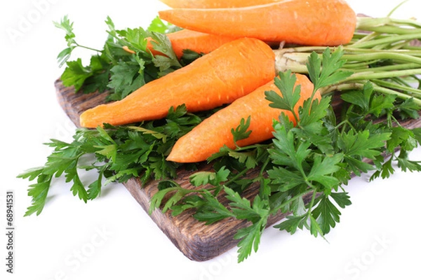 Fototapeta Carrots and parsley on cutting board isolated on white