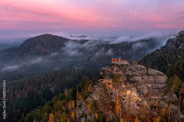 Fototapeta Jetrichovice, Czech Republic - Aerial view of Mariina Vyhlidka (Mary's view) lookout with foggy Czech autumn landscape and colorful pink sunrise sky in Bohemian Switzerland National Park