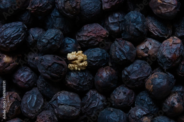 Obraz Fresh light walnut on old black walnuts