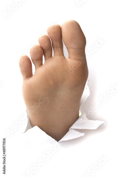 Obraz Foot with thumb up through a hole in paper