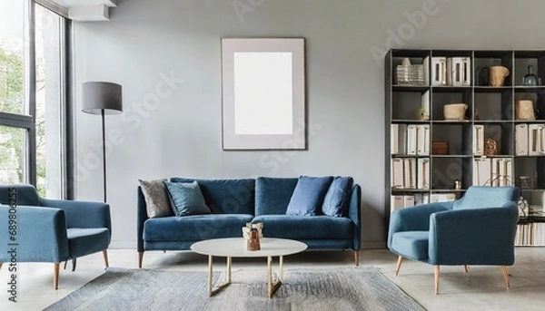 Fototapeta Blue sofa and chair against floor to ceiling window with forest view. Scandinavian home interior design of modern living room