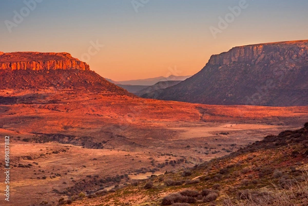 Fototapeta Rugged terrain and glowing mountains in a remote part of Lesotho, Africa