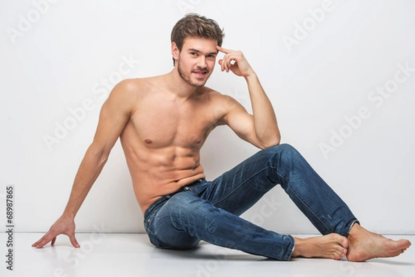 Obraz Handsome guy in jeans with bare torso.