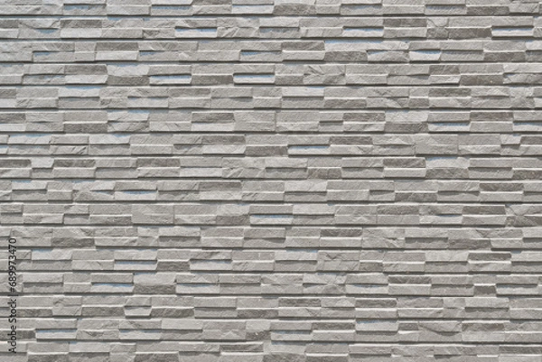 Fototapeta Bumpy stone, a timeless finishing material for exterior walls of buildings