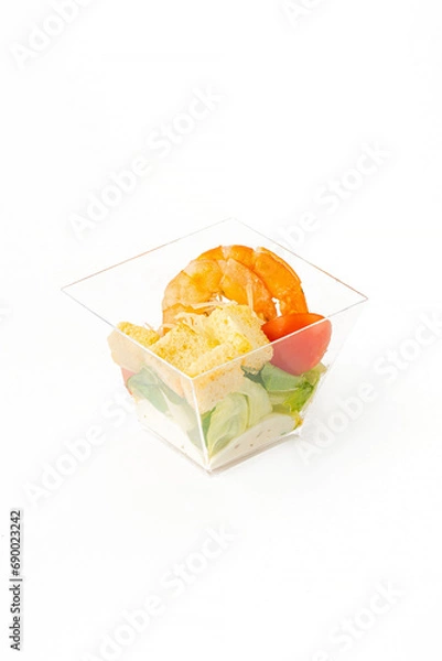 Fototapeta A small portion of vegetable salad on a white background