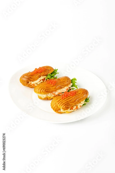 Fototapeta Sandwich with ham and red caviar on a white background