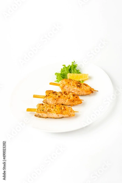 Fototapeta Meat snacks on a white plate on a white background
