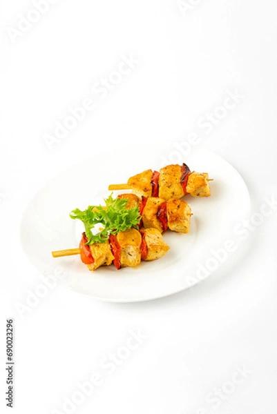 Fototapeta Meat snacks on a white plate on a white background