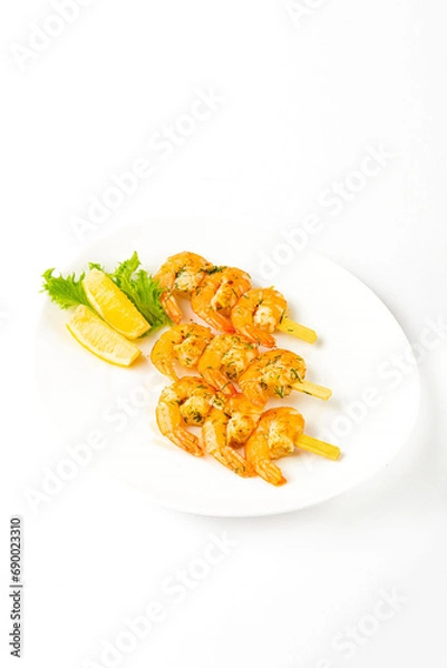 Fototapeta Meat snacks on a white plate on a white background