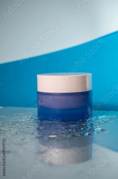 Fototapeta Water Elegance: Delicate Cosmetic Container on Water Drops with Vertical Shadows, Copy Space