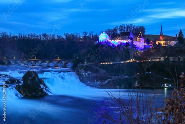 Obraz Laufen, Switzerland - January 08. 2022: Rhinefalls and Castle Laufen with Christmas illumination at the blue hour time
