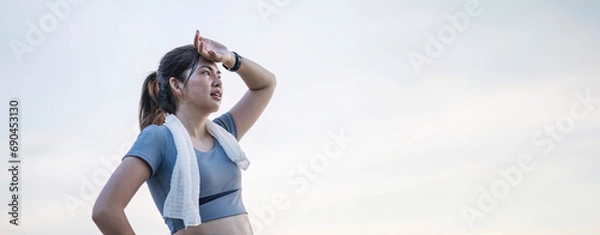 Fototapeta Asian woman is exhausted and wipes away sweat after running, jogging, exercising or exercising in the morning. sports for health Tired and out of breath Freshness and sweating