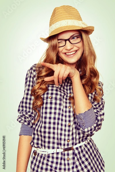 Fototapeta portrait of a cute young woman with casual garb pointing to the