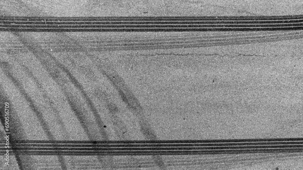 Obraz Aerial top view car tire marks burnout, Tire marks on the asphalt road, Tire mark on race track texture and background.