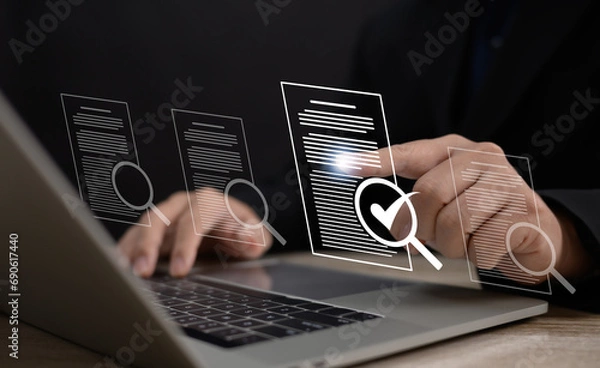 Fototapeta Performance checklist concept : businessman using stylus pen with laptop for questionnaire, evaluation, assessment online or survey exam and filling out for digital survey and checklist.	