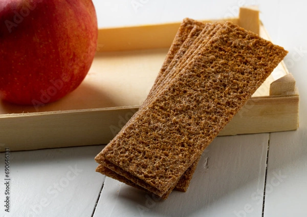 Obraz Rye bread and an apple, a healthy snack.