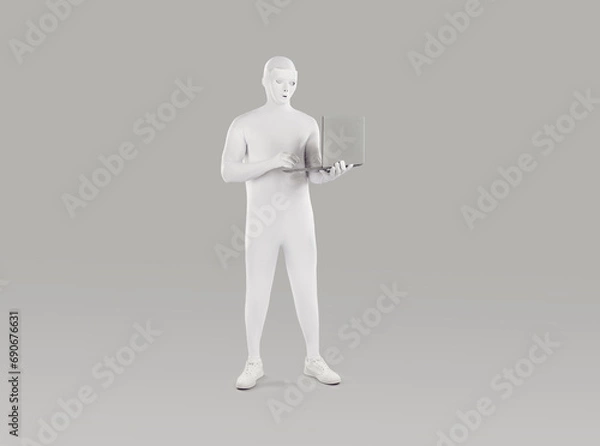 Obraz Incognito man figure in bodysuit standing and working on a laptop isolated on grey studio background. Full length portrait of faceless unrecognizable person wearing white spandex costume.